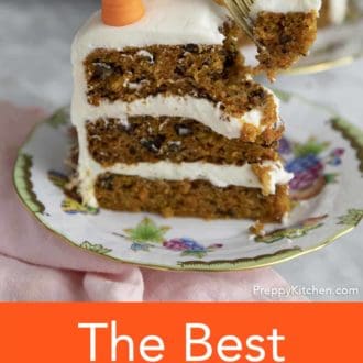 A piece of carrot cake being eaten with a gold fork.