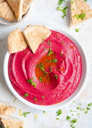 An overhead shot of beetroot hummus in a bowl