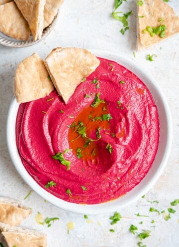 An overhead shot of beetroot hummus in a bowl