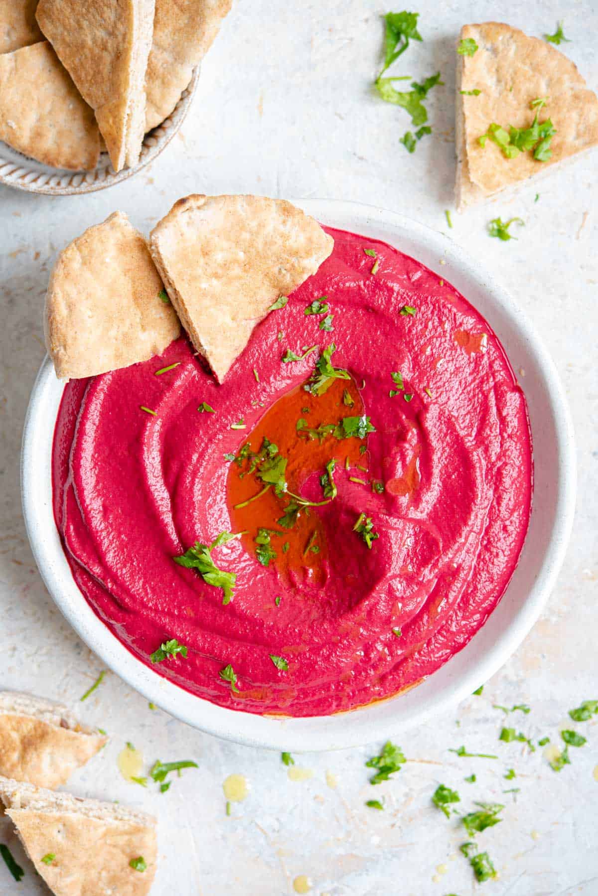 An overhead shot of beetroot hummus in a bowl