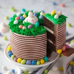 A slice of bunny butt cake sliced and lifted from the rest of the cake on a cake stand.