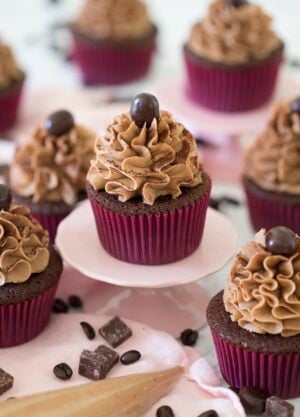 Mocha Cupcakes with chocolate and coffee beans around them.