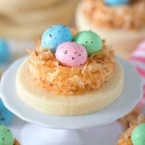a sugar cookie with pastel chocolate eggs in a coconut nest.