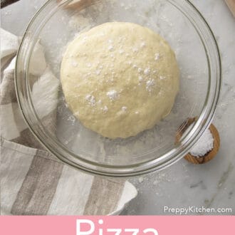 Pizza Dough rising in a glass bowl.