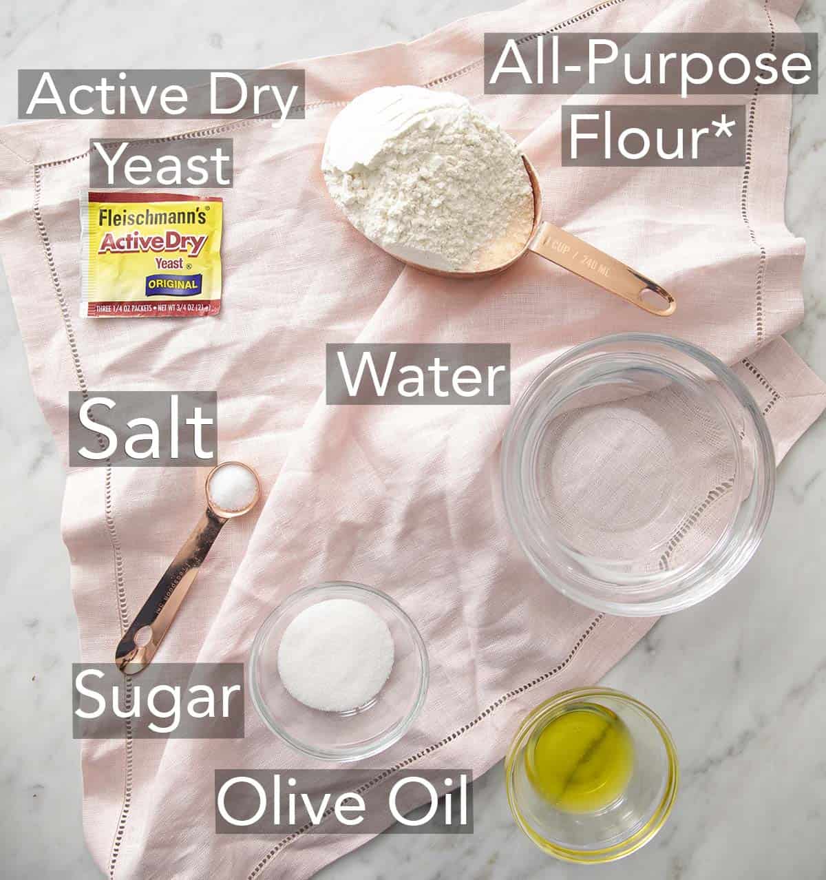 Ingredients for making pizza dough on a counter.