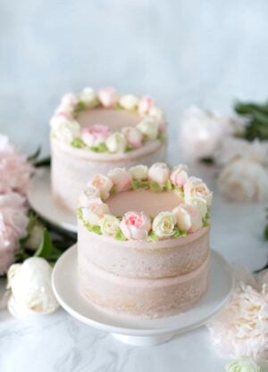 photo of two Smash Cakes on a table with flowers