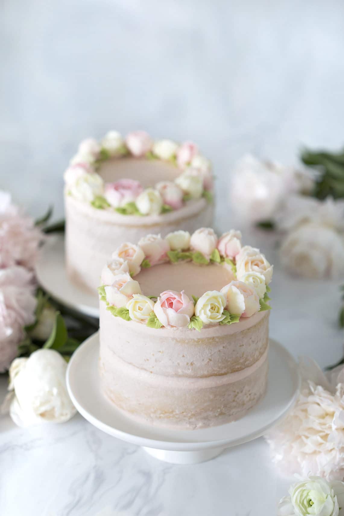 photo of two Smash Cakes on a table with flowers