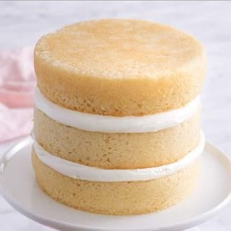 An unfrosted stack of three flat cake layers