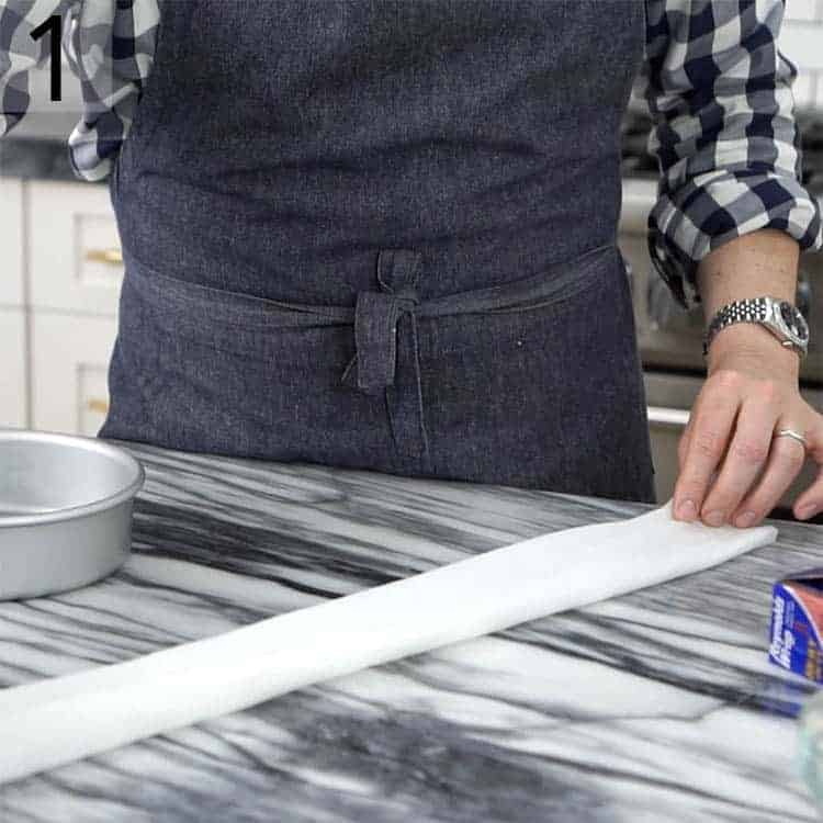 Paper towels getting folded to make homemade cake strips.