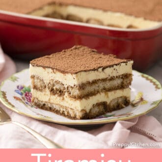 A piece of tiramisu in front of a red baking dish.