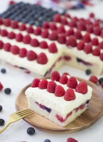 An American flag cake made with berries on a marble table