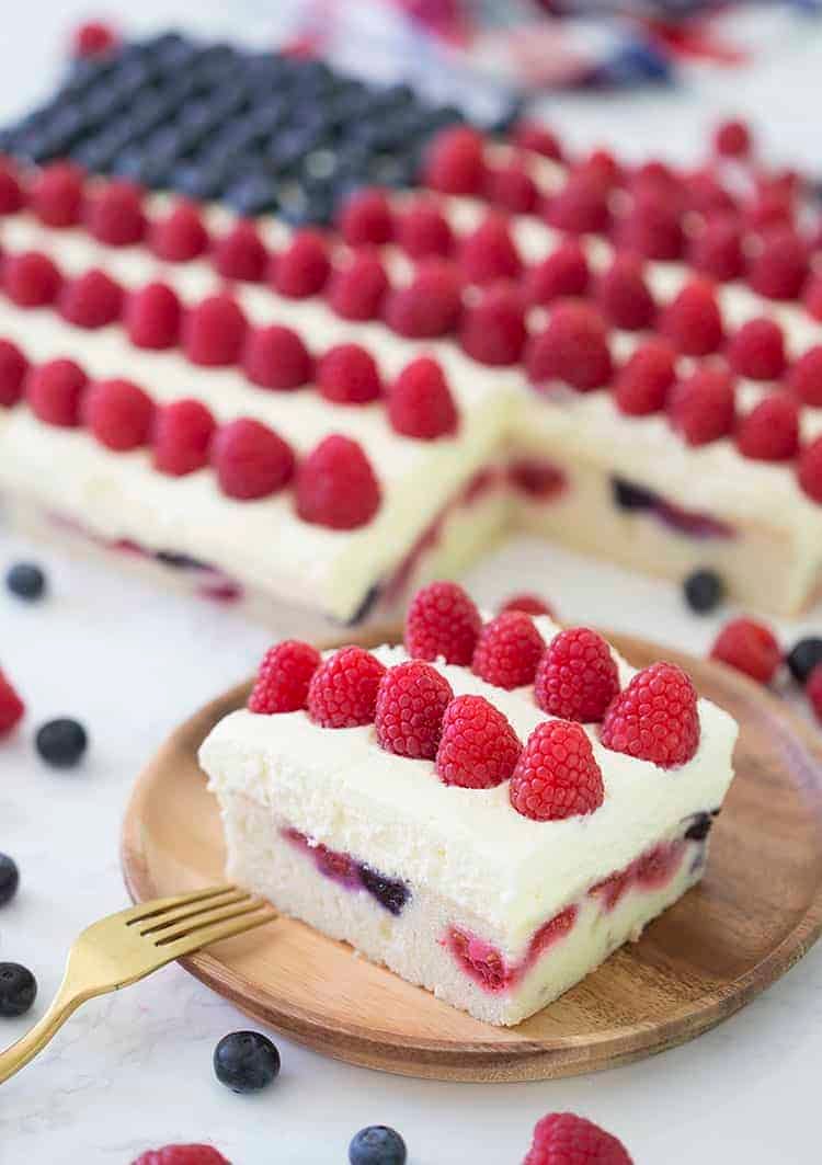 An American flag cake made with berries on a marble table