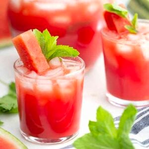 two glasses of watermelon agua fresca with mint leaves for garnish