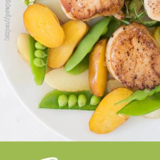 Seared scallops with baby potatoes, peas and salad