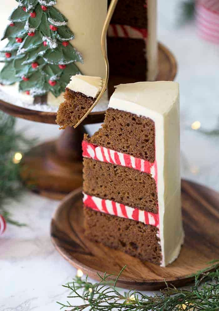 A photo of a piece of gingerbread cake being eaten with a gold fork