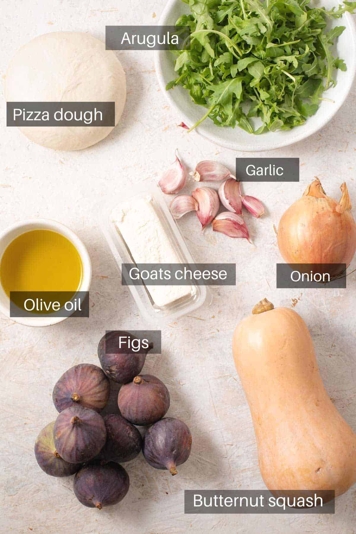 An overhead shot of all the ingredients you need to make a fig pizza