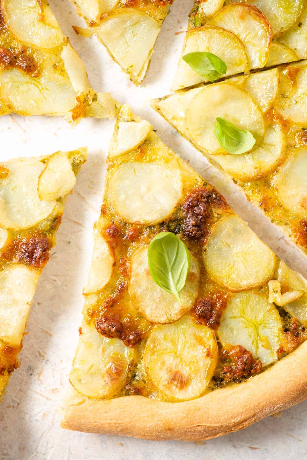 A close up of a slice of pizza topped with potatoes