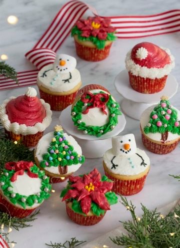 A photo of Christmas cupcakes on a white marble table