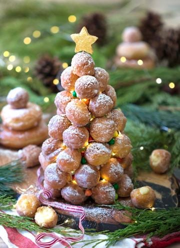 A photo showing a crquembouche made from donut holes with LED mini lights