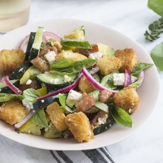 A photo of a panzanella salad on a plate ready to be served.