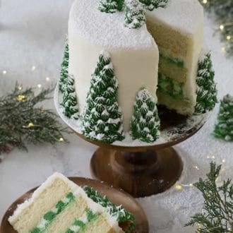 christmas cake with christmas tree decoration topped in powdered sugar