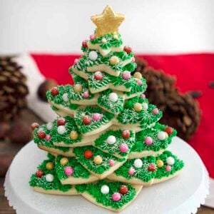 A Christmas Cookie tree on a white cake stand.
