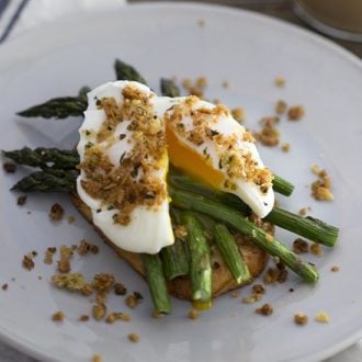 A photo of a poached egg on asparagus and toast