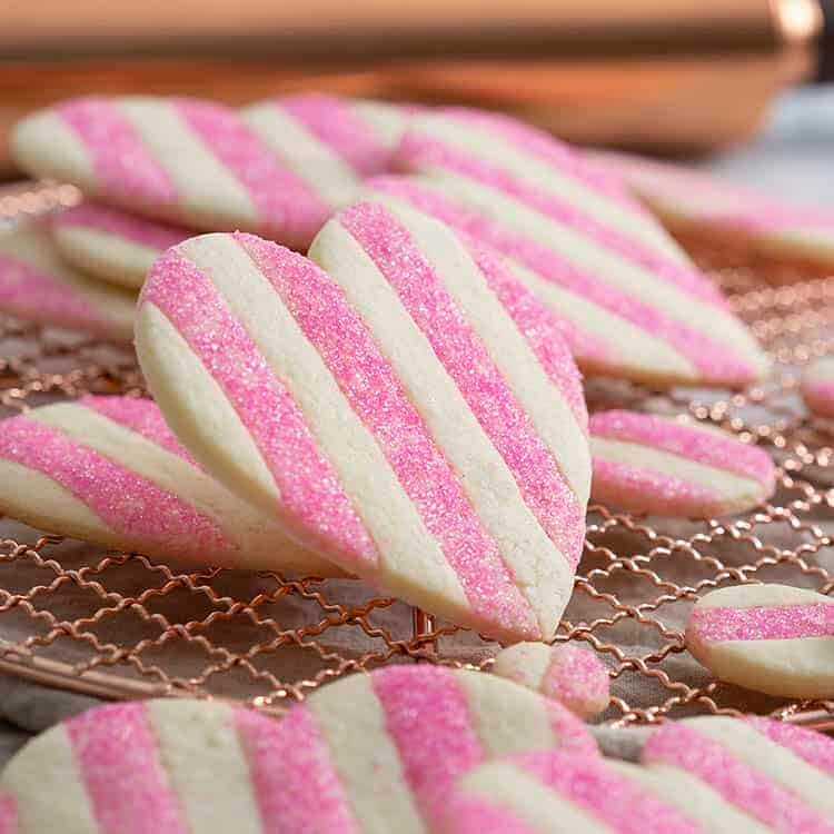 Heart-shaped Valentine's day sugar cookies with pink stripes.