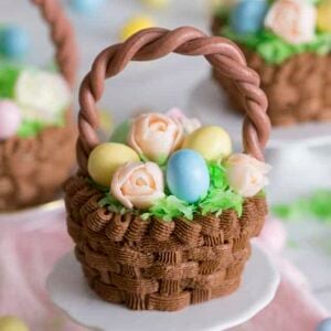 Chocolate Easter basket cupcakes filled with candy eggs and flowers.