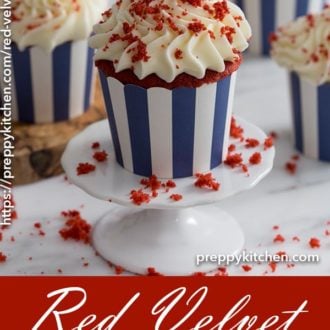 A clipping of a red velvet cupcake on a cupcake stand with red velvet crumbles on top.