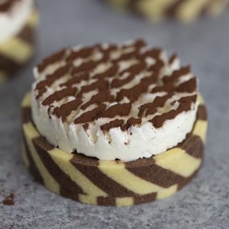 A photo of a chocolate tart with a striped pastry shell.