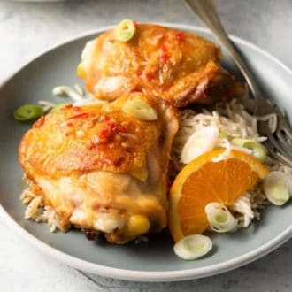 Orange chicken pieces with scallions and noodles