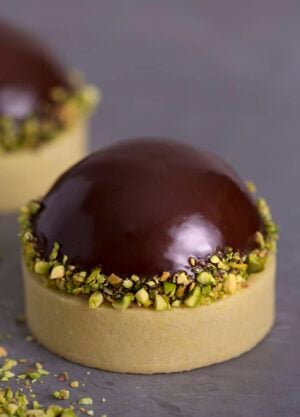A pistachio tart topped with a chocolate dome