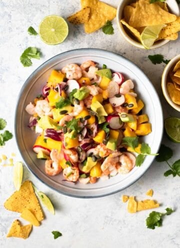 An overhead shot of shrimp ceviche in a bowl with tortilla chips