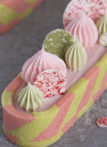 a closeup photo of a pink and green tast with dollops and circles on top