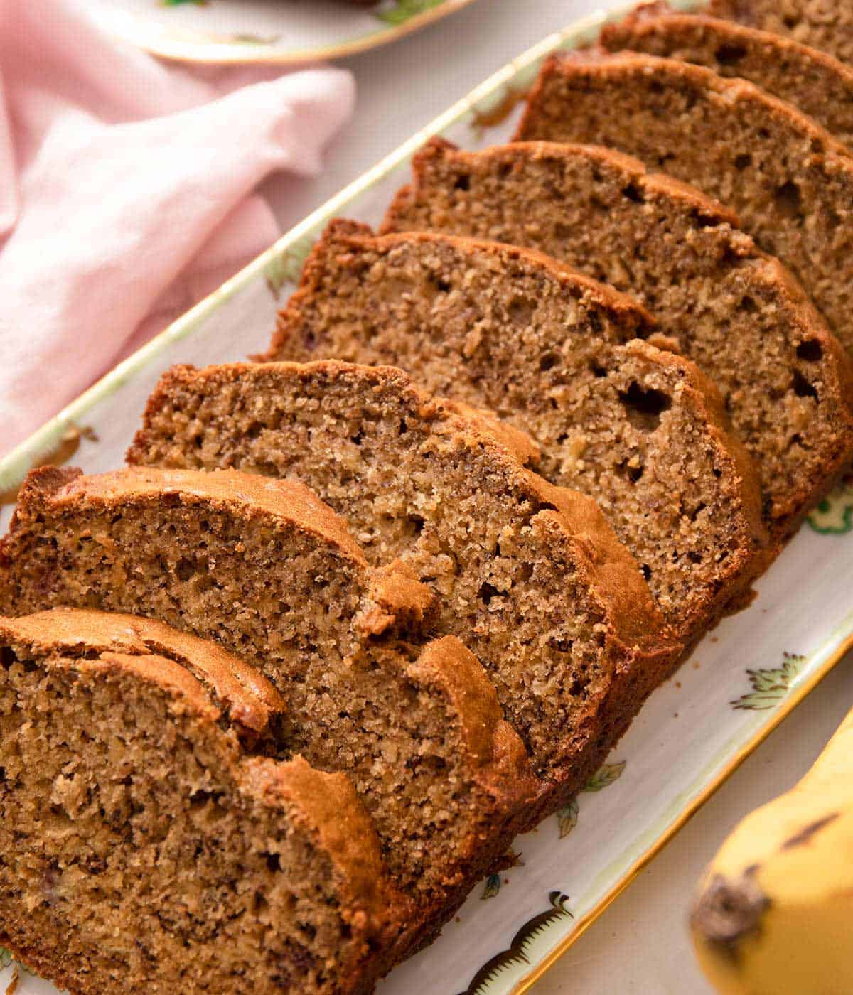 Banana bread cut into slices on a serving plate