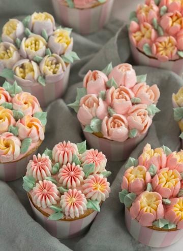 a photo of cupcakes topped with buttercream flowers using Russian piping tips
