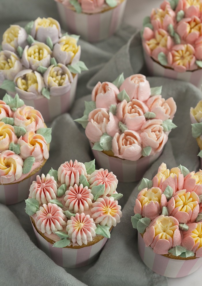 a photo of cupcakes topped with buttercream flowers using Russian piping tips