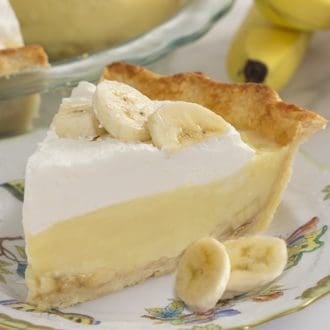 a piece of banana cream pie with banana slices scattered around