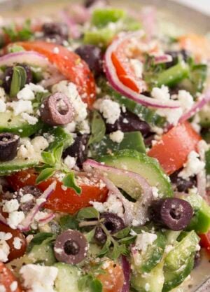 A closeup shot of Greek Salad with tomatoes cucumber and feta.