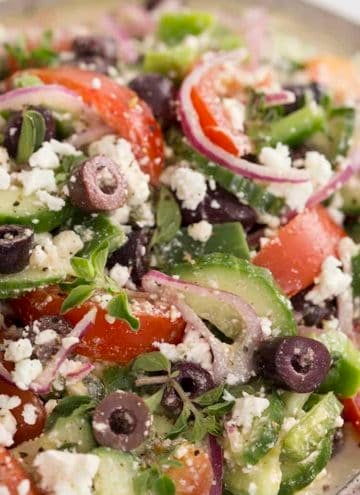 A closeup shot of Greek Salad with tomatoes cucumber and feta.