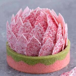 A tart with pink petals that looks like a lotus flower