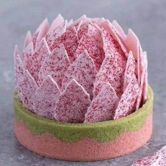 A tart with pink petals that looks like a lotus flower