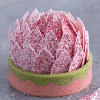 A tart with pink petals that looks like a lotus flower