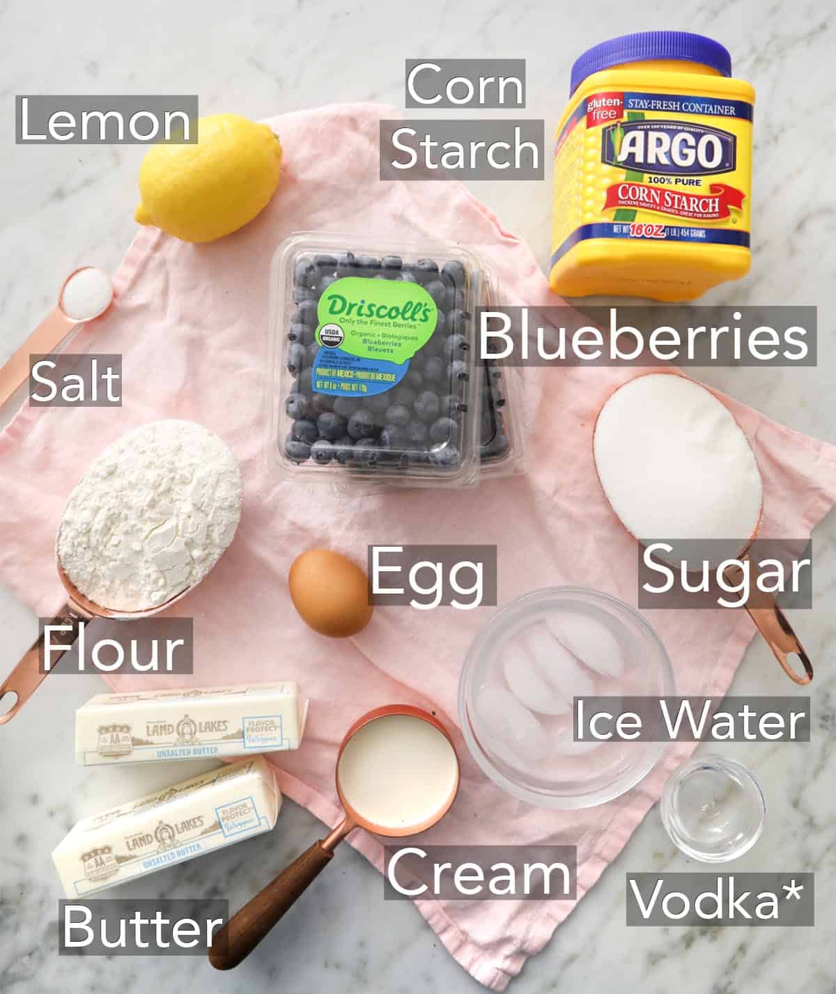 Ingredients for making blueberry pie on a counter.