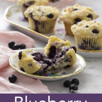 Pinterest graphic of a blueberry muffin cut open in half on a plate with more on a platter behind him. Fresh blueberries scattered around.
