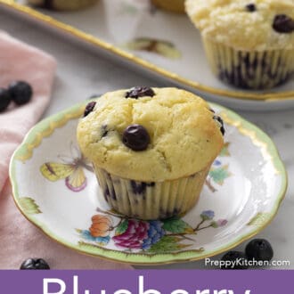 Pinterest graphic of a plate with a blueberry muffin with a platter with three more in the background.