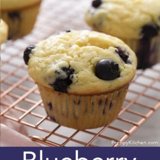 Pinterest graphic of a close view of a blueberry muffin on a wire cooling rack.