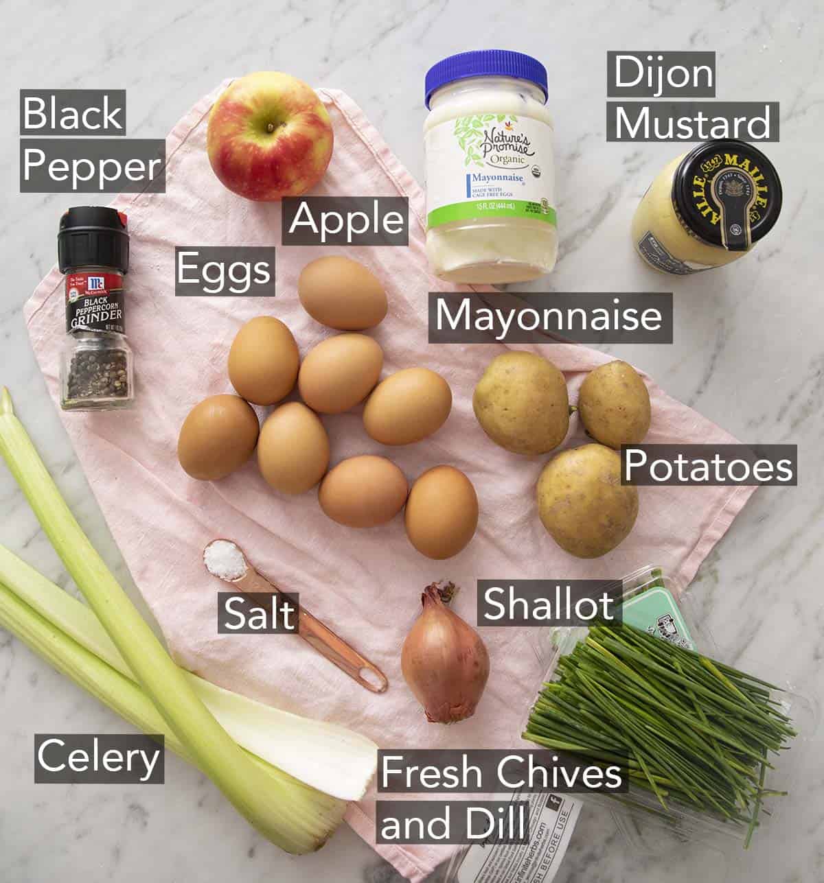 Ingredients to make egg salad on a marble counter.