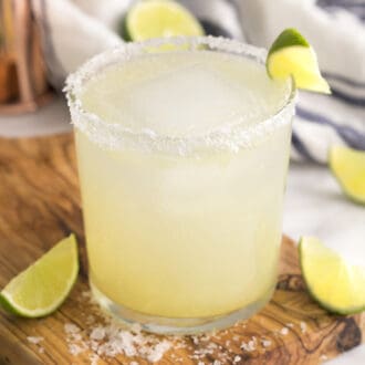 A margarita on the rocks with salt in a tumbler.